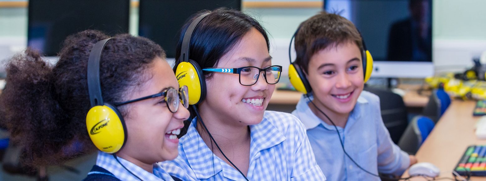 children wearing headphones for a lesson at prep school