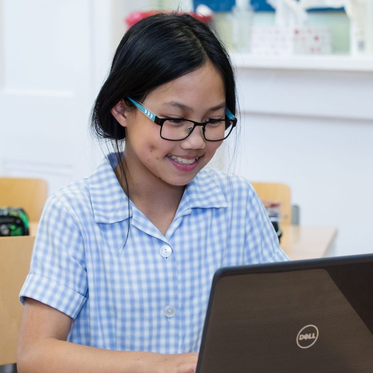 A girl using a laptop at a London private school
