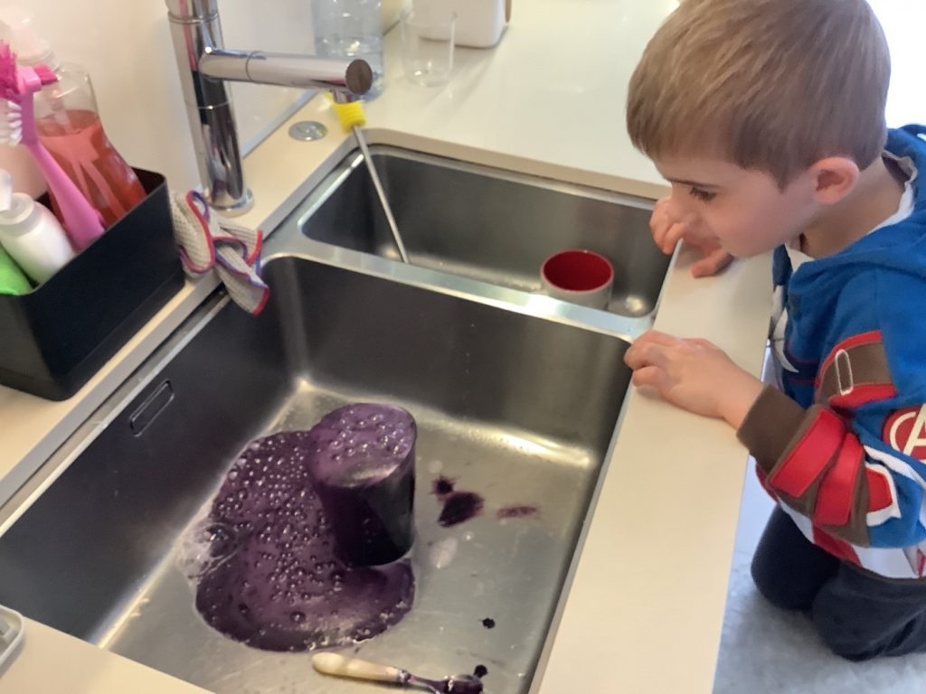 A schoolchild making a "potion" at home by following a science experiment