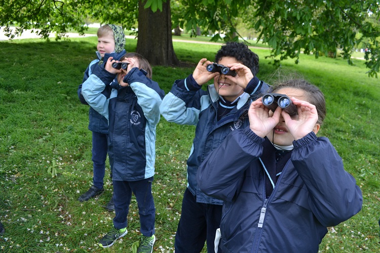 children using binoculars at a London prep school