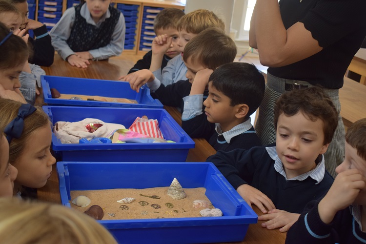 Children at a private school in London playing with sand and shells