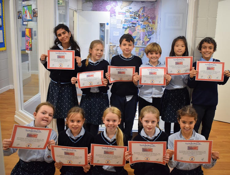 Children at a prep school in London with their numberella awards
