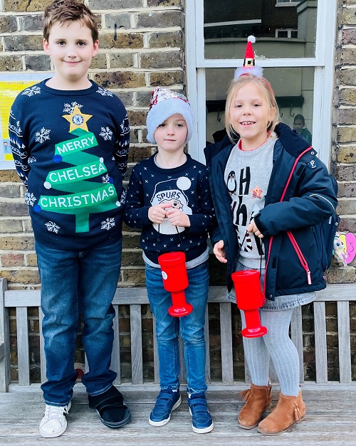 Children wearing Christmas jumpers outside of London prep school