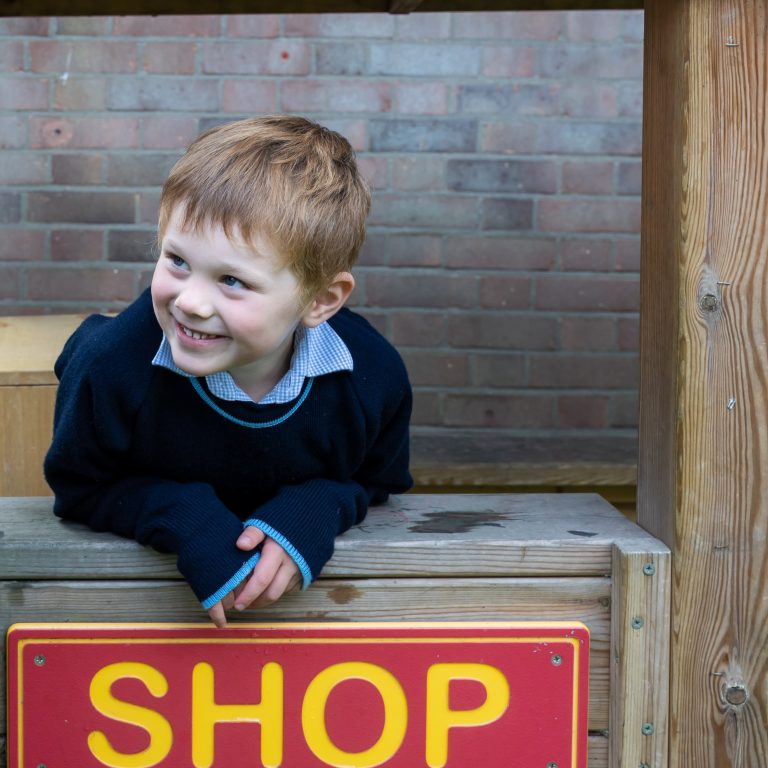 child stood at the shop window