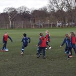 children playing football on the football pitch