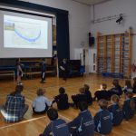 children sat in the hall watching a presentation