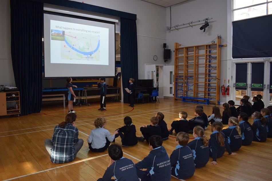 children sat in the hall watching a presentation