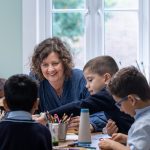 teacher sat with pupils