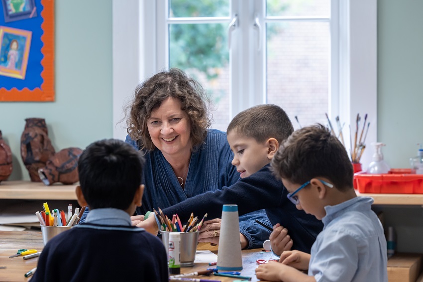 teacher sat with pupils