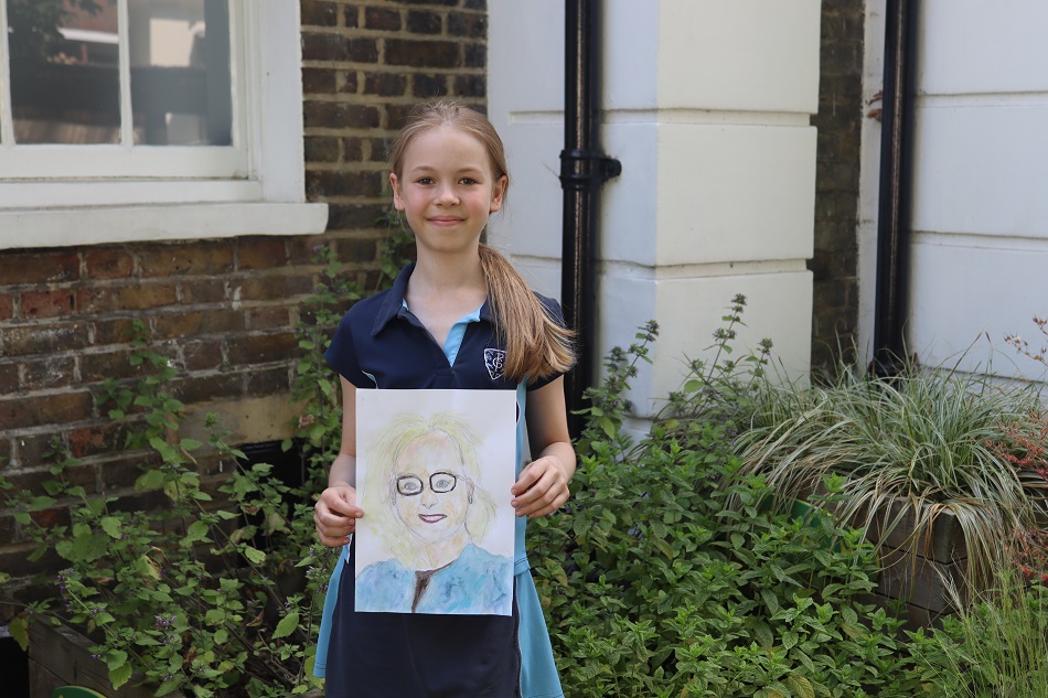 Student with a drawing in their hands