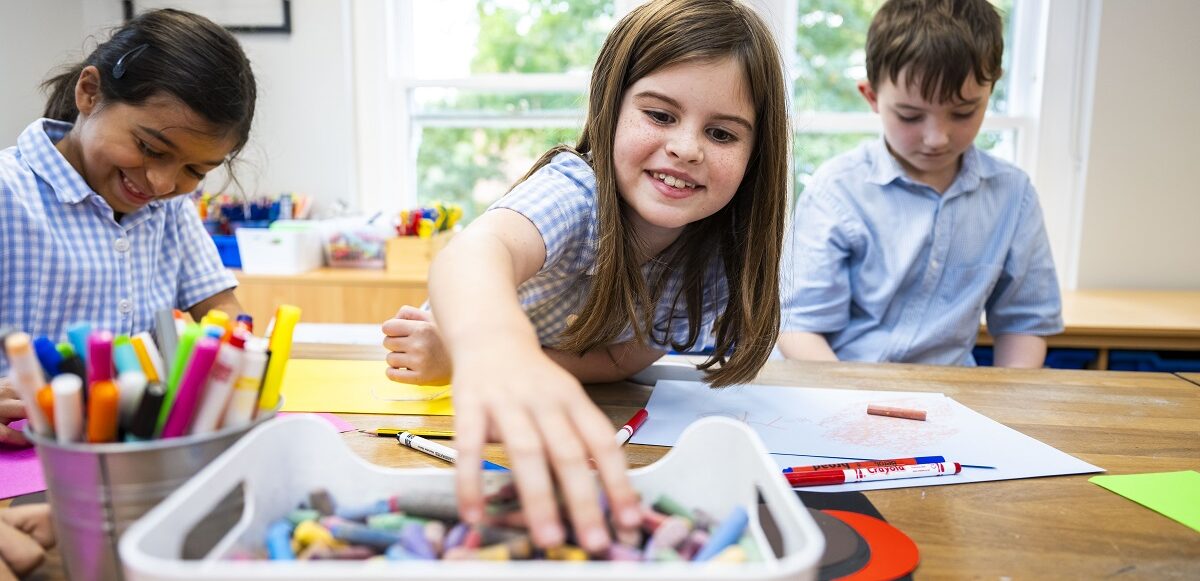 child grabbing crayons