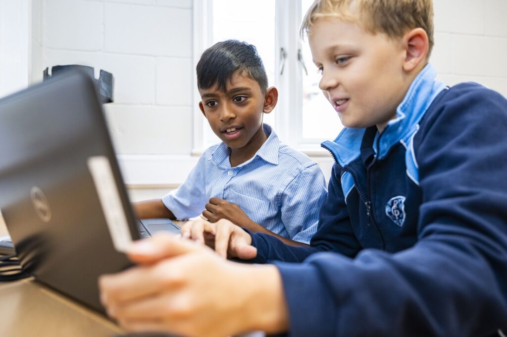 2 boys using a laptop