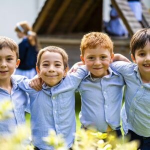 4 boys with their arms around each other