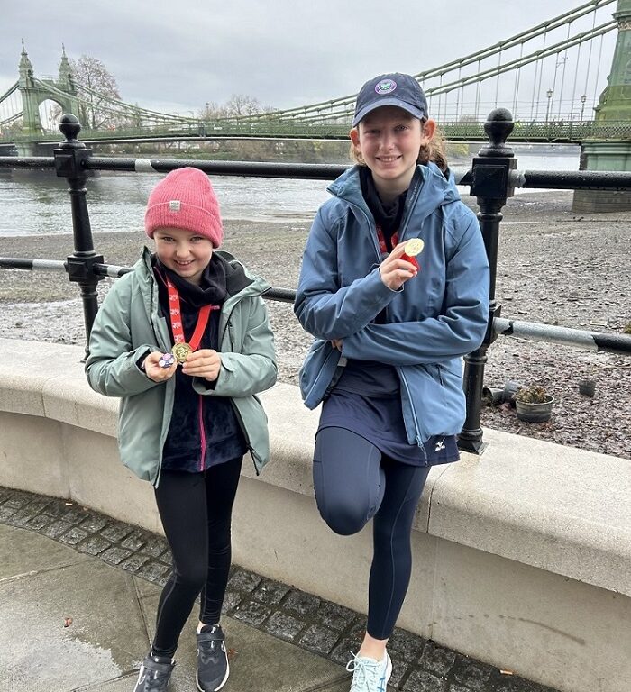 students wearing medals after running 7km