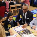 students at a table with parent