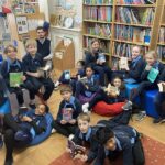 students relaxing on beanbags with books in hand