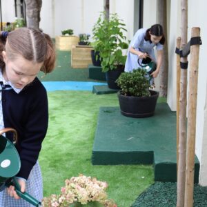 student watering a plant